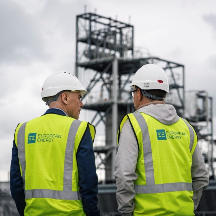 Our CEO and guest looking at Kassø E-methanol Facility with their backs turned